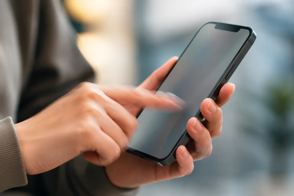 Person tapping an unresponsive iPhone touch screen